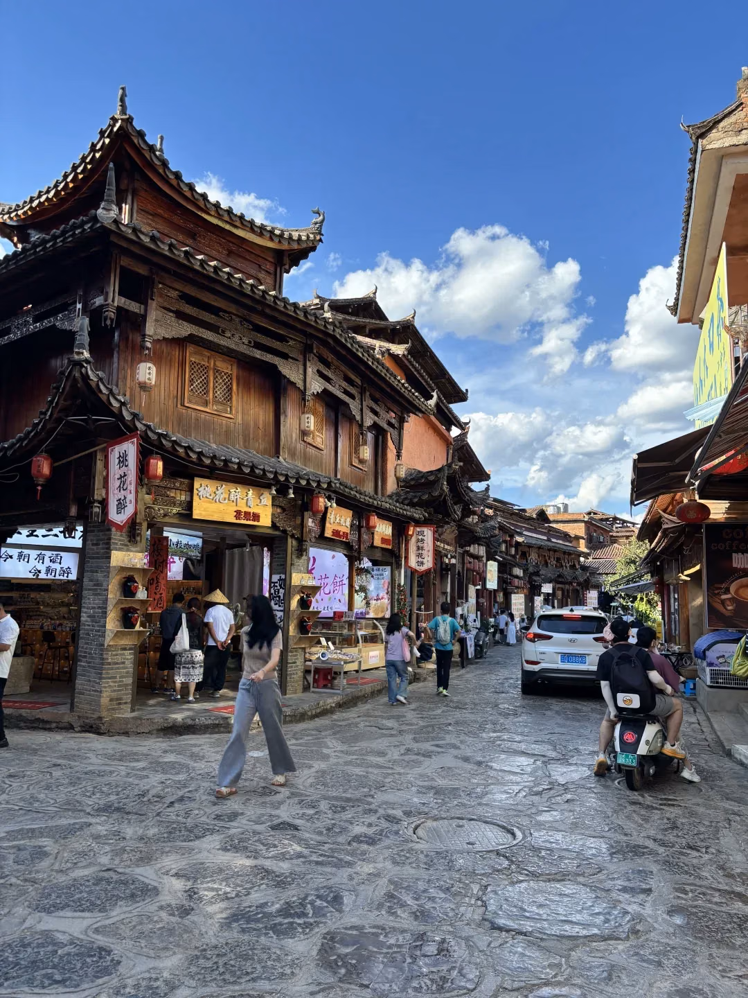 Paved street and wooden shopfronts in Xianrendong village, Puzhehei