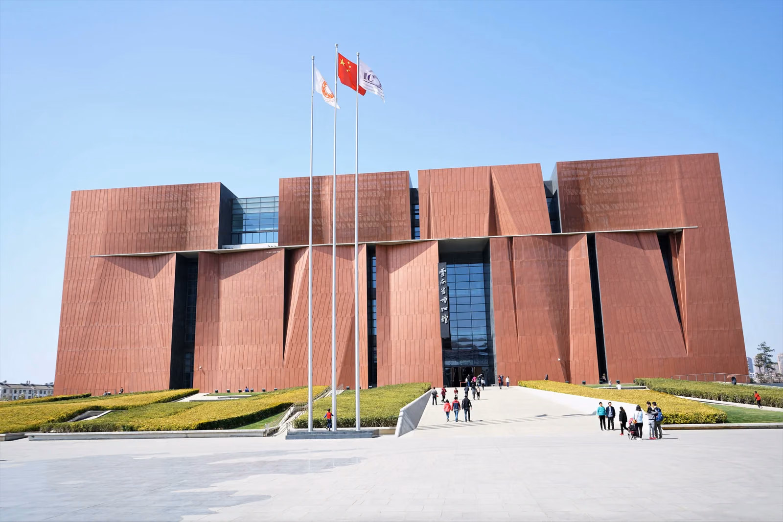 Red geometric facade and forecourt of the Yunnan Provincial Museum in Guandu, Kunming