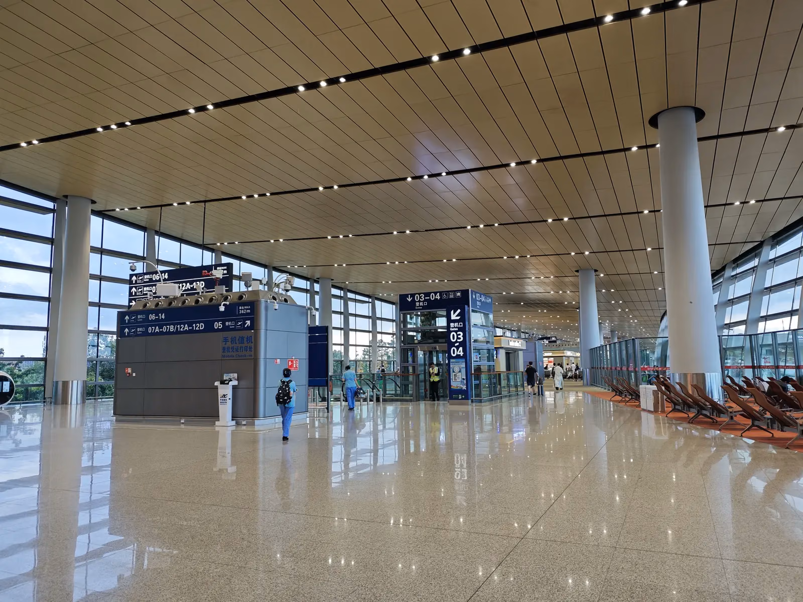 Terminal corridor and signs for gates 3 and 4 at Kunming Changshui International Airport